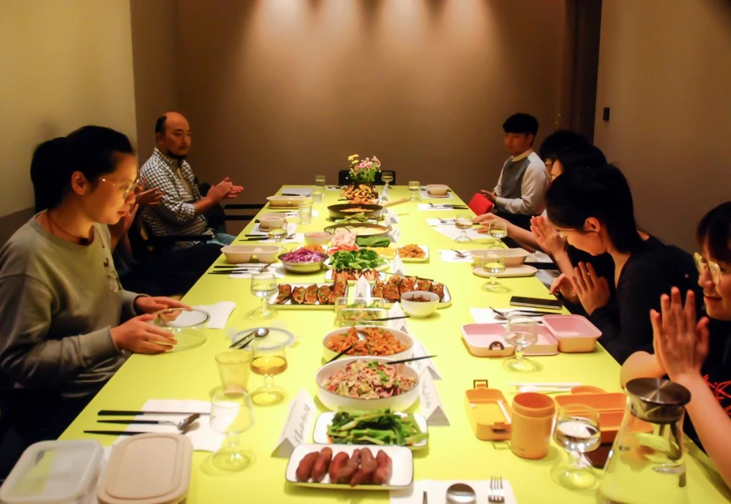 People sharing a table in a community space