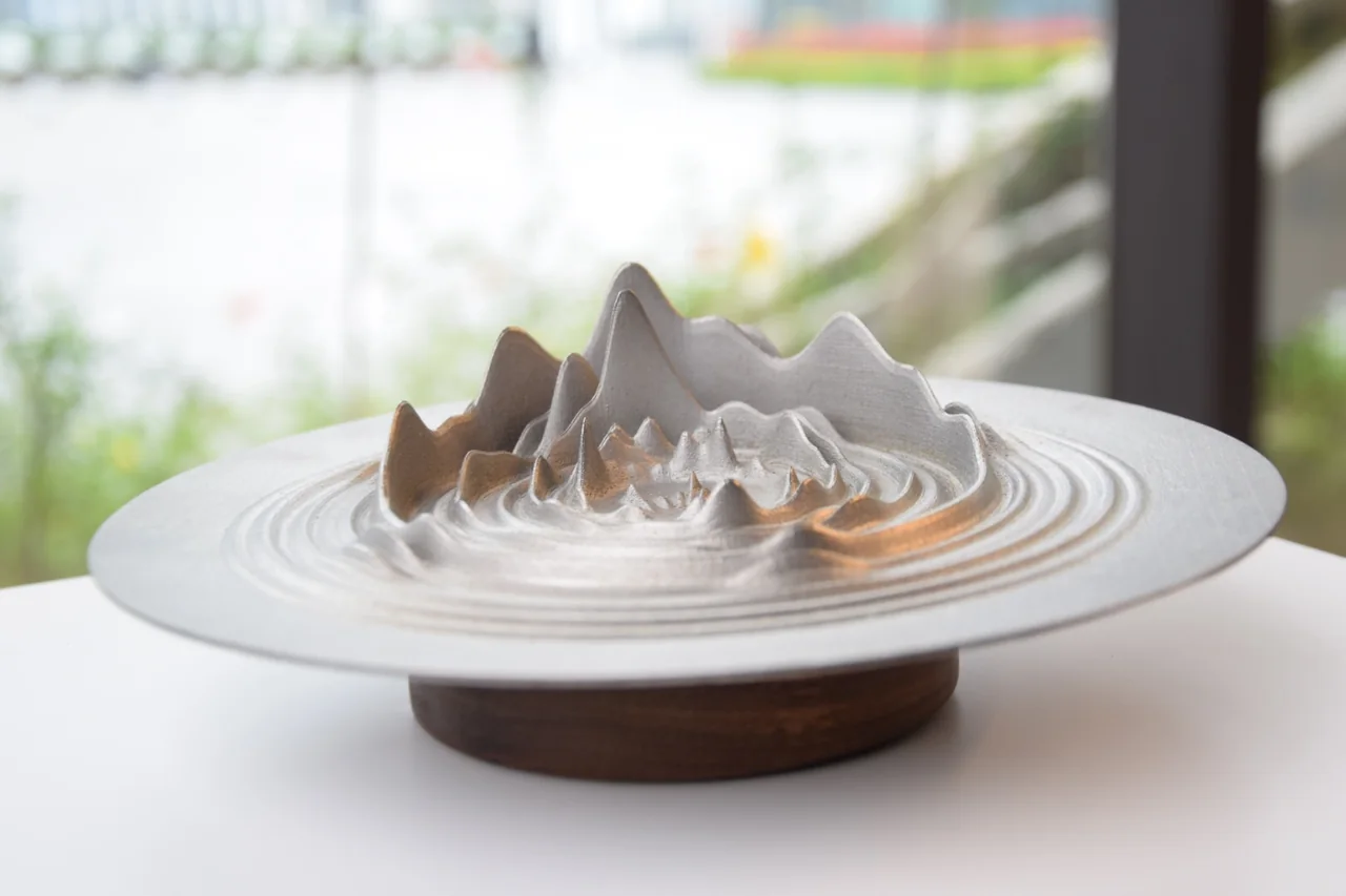 A sculptural object with wave-like contours in the Beautiful is in the Waves exhibition